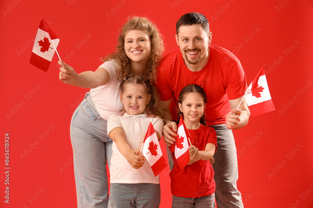 Happy beautiful family with flags of Canada on red background Happy beautiful family with flags of Canada on red background