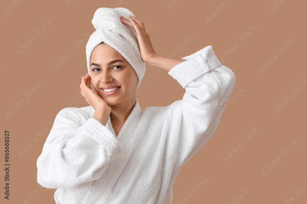 Beautiful young happy woman in bathrobe with towel on beige background Beautiful young happy woman in bathrobe with towel on beige background