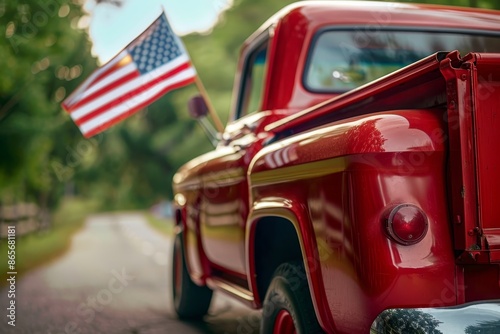 Close view of red truck with American flag waving on 4th of July