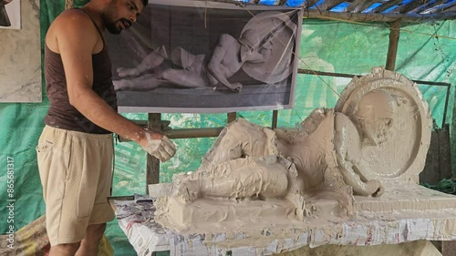 Behind the Scenes: Indian artist Casting Mold of Laomedon clay sculpture with Plaster of Paris. photo