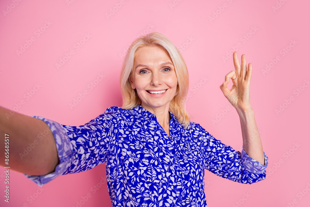 Portrait of nice elegant lady make selfie show okey wear blue shirt isolated on pink color background Portrait of nice elegant lady make selfie show okey wear blue shirt isolated on pink color background