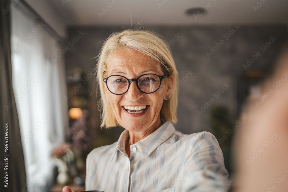 Self portrait of senior woman stand and take picture of herself