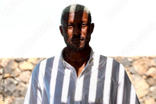 Mature man with graying hair looking directly at camera