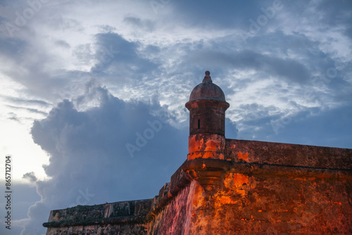 Old Sentry Box on Curtain Wall at National park Castillo San Felipe del Morro Fortress lighted up at at dusk in old San Juan, Puerto Rico, a UNESCO site photo