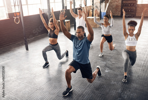Class, fitness and lunge in group at gym for workout, core exercise or training together indoors. Diverse people, friends or warm up for ab muscle, session and sport for health challenge in gymnasium