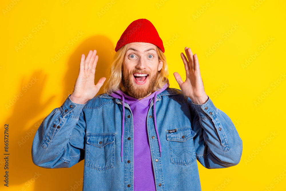 Photo portrait of attractive young man look camera amazed reaction dressed stylish denim clothes isolated on yellow color background