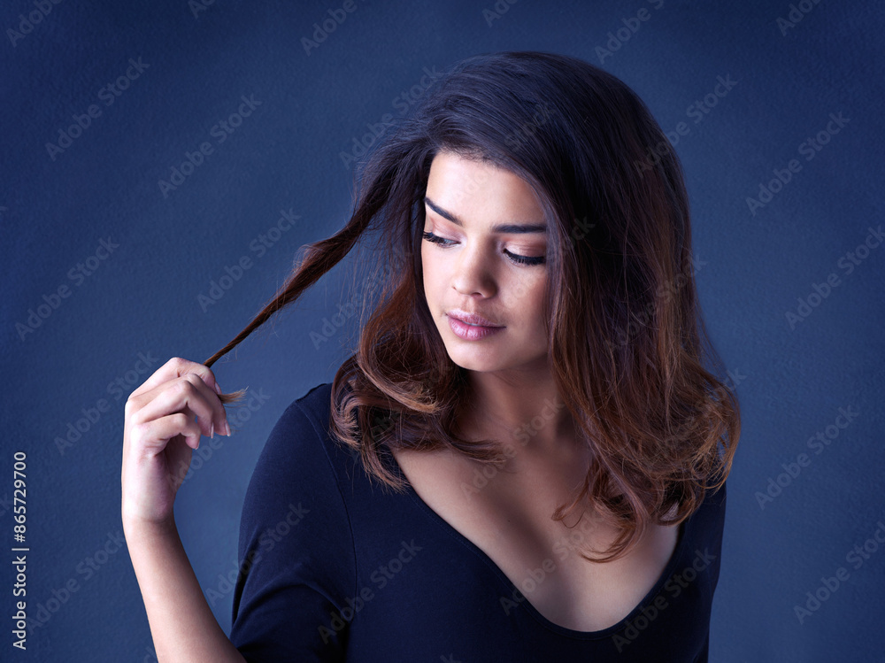 Fototapeta premium Hair, soft and woman in studio for cosmetic, shine and shampoo results on blue background. Haircare, beauty and gen z girl model with smooth, texture or growth from scalp treatment or satisfaction