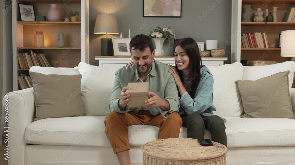 Boyfriend open his birthday present from his girlfriend at home Boyfriend open his birthday present from his girlfriend at home