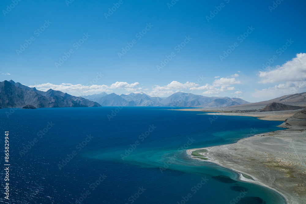 The blue waters of Pangong Lake in summer are surrounded by the Himalayas. The blue waters of Pangong Lake in summer are surrounded by the Himalayas.
