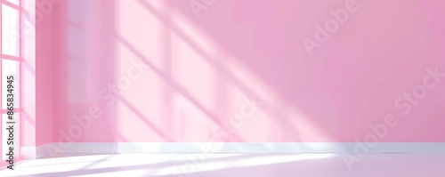 Sunlight streaming through windows casts shadows on a pink wall, creating a soft and dreamy atmosphere in an empty room.
