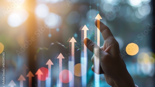 Hand pointing at upward arrow graph, symbolizing growth, success and positive trends in business or finance.