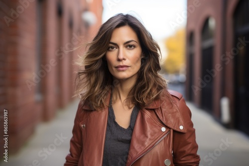 Portrait of a beautiful young brunette woman in a leather jacket © Stocknterias
