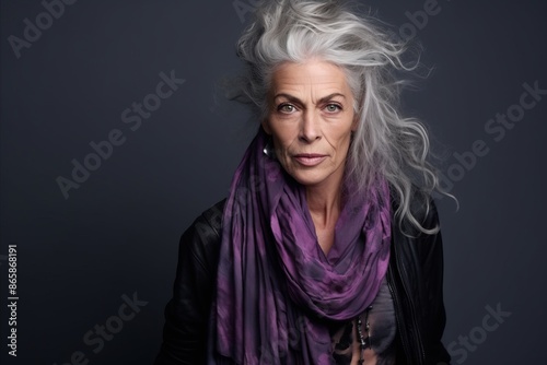 Portrait of a beautiful senior woman with grey hair and purple scarf