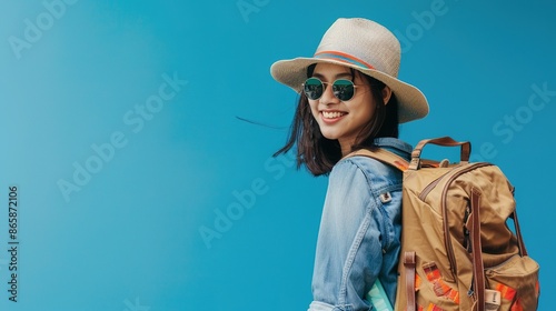 Smiling Woman in a Hat and Sunglasses with a Backpack