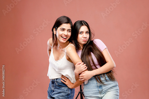 Two Good Friends Are Posing In Front Of The Camera While Holding Hands