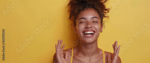 Woman With Brown Hair Laughing In Front Of Yellow Background
