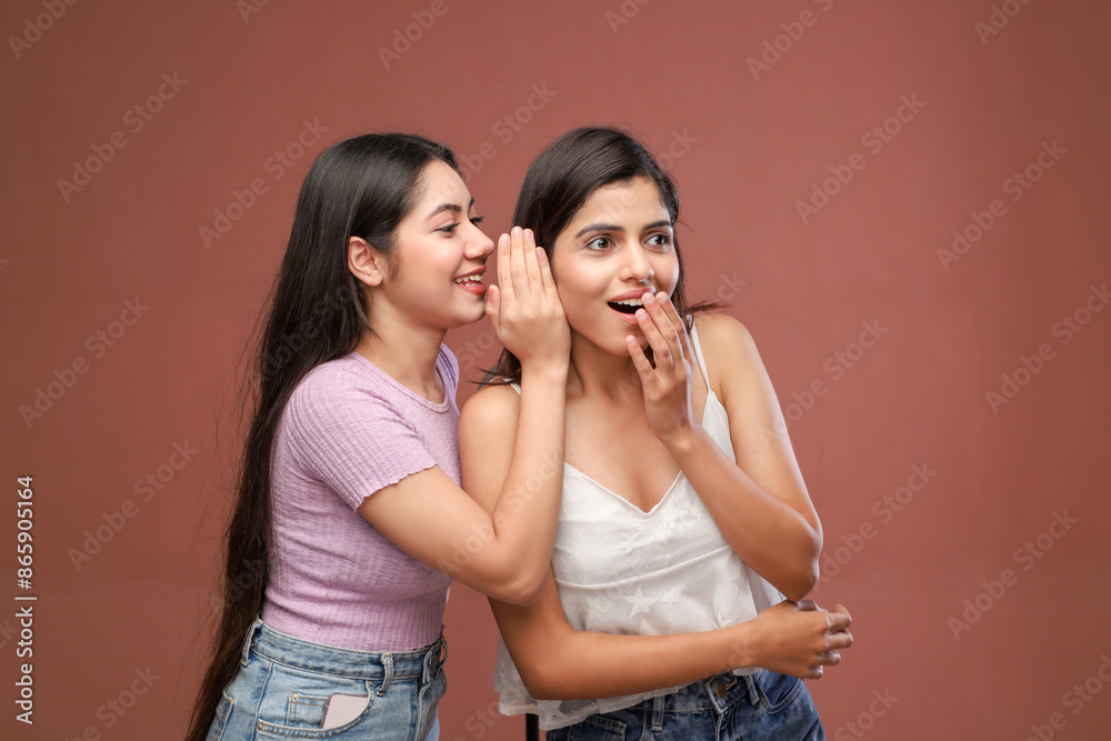 2 Girlfriends Are Gossiping And Having Fun And One Is Whispering A Secret In Her Friend's Ear 2 Girlfriends Are Gossiping And Having Fun And One Is Whispering A Secret In Her Friend's Ear