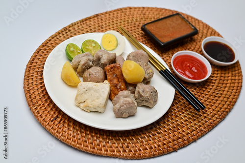 Siomay, a traditional Bandung dish, is a steamed dumpling made from mackerel fish and flour. It’s served with a rich peanut sauce, soy sauce, and chili sauce, offering a flavorful Indonesian culinary 