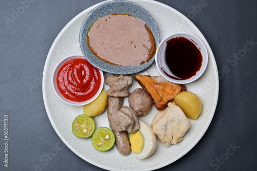Siomay, a traditional Bandung dish, is a steamed dumpling made from mackerel fish and flour. It’s served with a rich peanut sauce, soy sauce, and chili sauce, offering a flavorful Indonesian culinary 