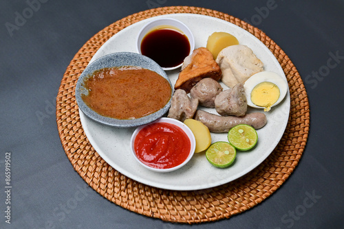 Siomay, a traditional Bandung dish, is a steamed dumpling made from mackerel fish and flour. It’s served with a rich peanut sauce, soy sauce, and chili sauce, offering a flavorful Indonesian culinary  photo