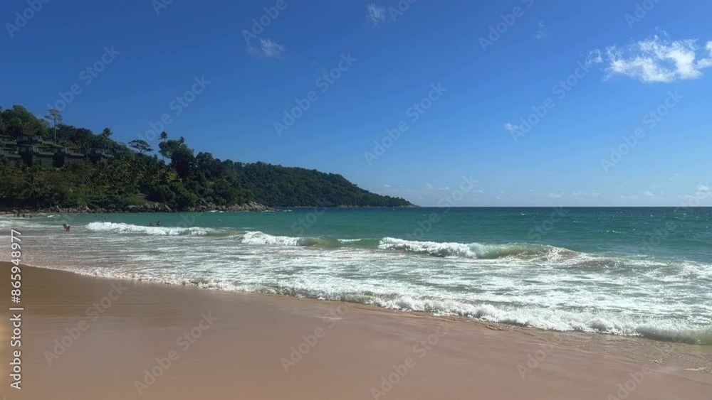 People enjoying a tropical beach with turquoise seas. Turquoise ocean on a sunny day. Summer holidays and paradise beach concept. Kata Noi, Phuket, Thailand. People enjoying a tropical beach with turquoise seas. Turquoise ocean on a sunny day. Summer holidays and paradise beach concept. Kata Noi, Phuket, Thailand.