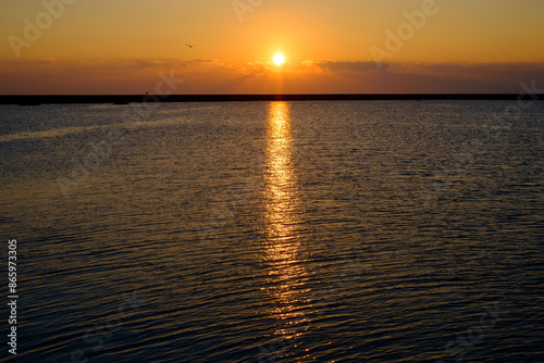 Golden Sunset Reflecting on Calm Ocean Waters