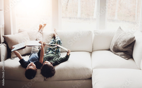 Photography Upside down, reading books and boys on couch, hobby and activity with fantasy, storytelling and relax