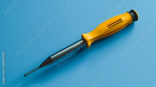 A screwdriver with a Phillips head, against a blue background. photo