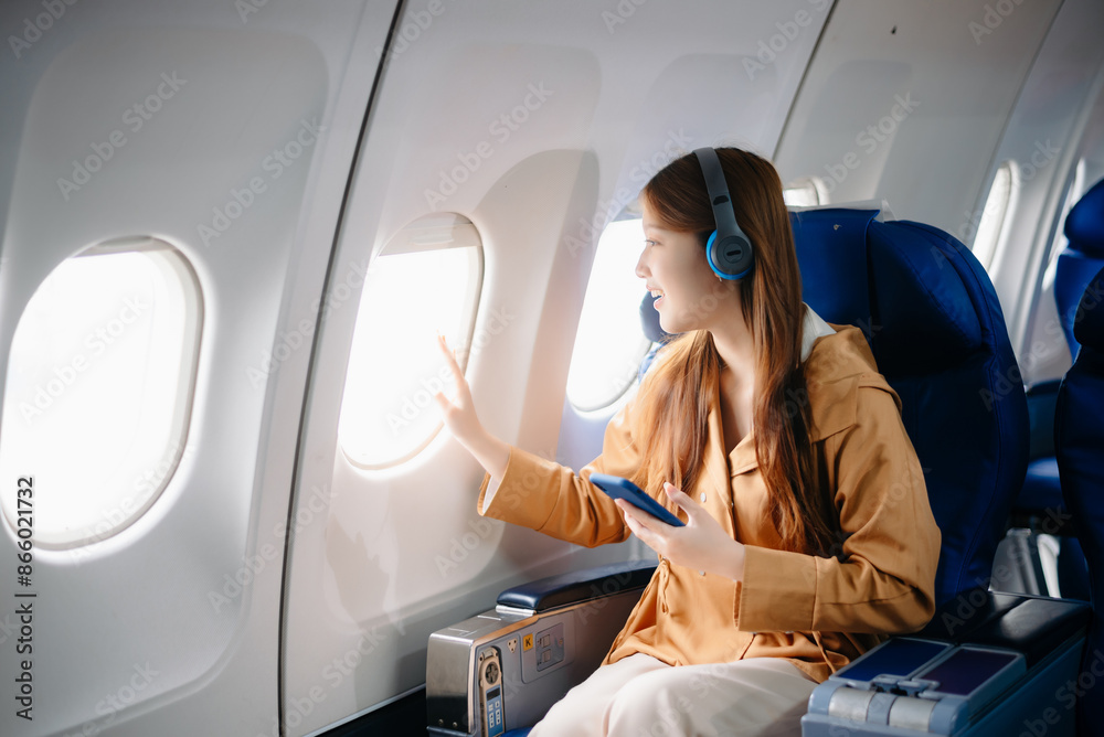 Asian Woman Working on Tablet During in first class, multitasking with Flight Travel in style, work Asian Woman Working on Tablet During in first class, multitasking with Flight Travel in style, work