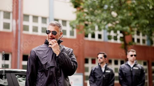 Luxury car business security guard providing VIP protection services, equipped