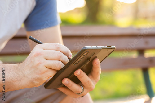 person writing on foldable phone with stylus