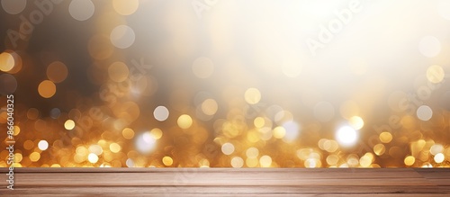 Abstract golden bokeh backdrop with a white textured wooden surface providing ample copy space image for text placement.