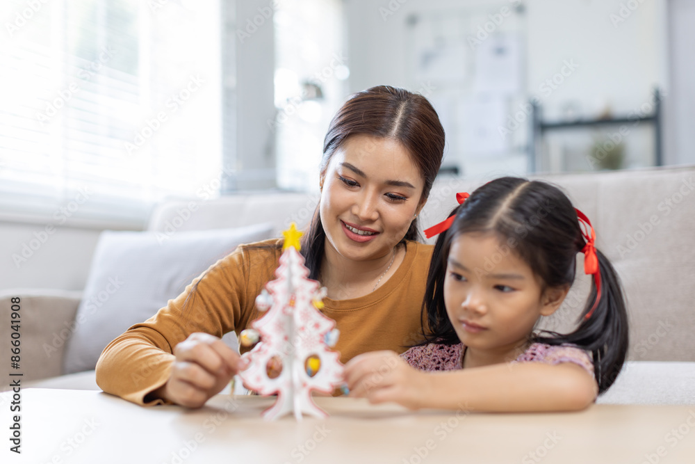 family, winter holidays and people concept - happy mother and little daughter decorating christmas tree at home
family, winter holidays and people concept - happy mother and little daughter decorating christmas tree at home