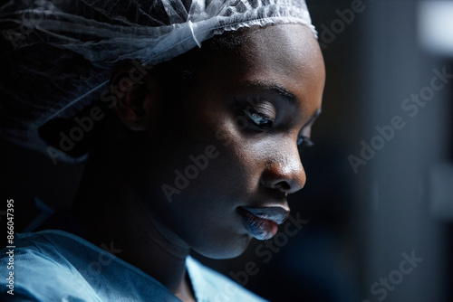 Bild auf Leinwand Side view closeup of young Black woman wearing protective clothing in operating