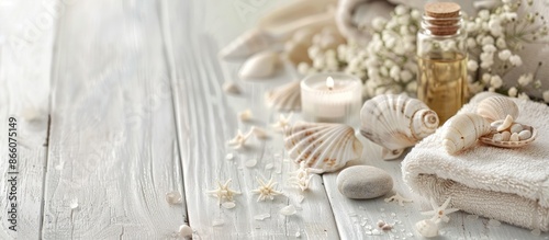 Close-up macro view of a spa arrangement on a white wooden background, featuring essential oil, stones, shells, candles, and a towel, promoting a serene and relaxing atmosphere, ideal for text banner