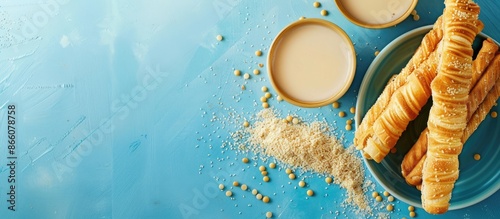 Blue background features a deep-fried dough stick and soybean milk, with copy space image available. photo