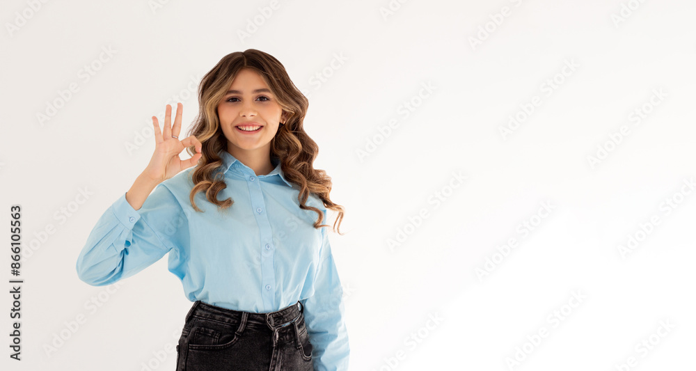 Young beautiful woman wearing blue shirt over isolated white background smiling positive doing ok sign with hand and fingers. Successful expression. Young beautiful woman wearing blue shirt over isolated white background smiling positive doing ok sign with hand and fingers. Successful expression.