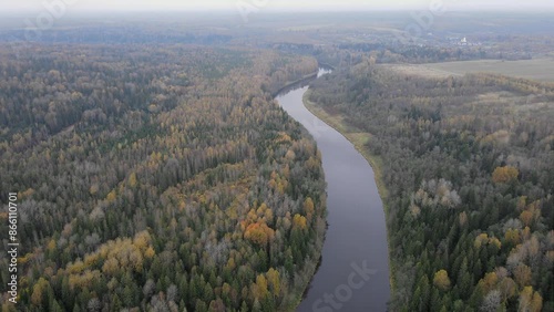 a flight from above over the Volga river surrounded by an autumn forest in the Tver region. Enviroment concept. High quality 4k footage