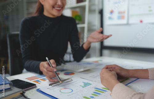 Team work process Team of business people searching for piles of papers and having a meeting Discuss business statistics, profits, financial growth rates in graph papers. financial data chart.