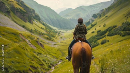 A breathtaking macro shot capturing a tourist horseback riding through a picturesque valley, surrounded by lush greenery and under a clear blue sky photo