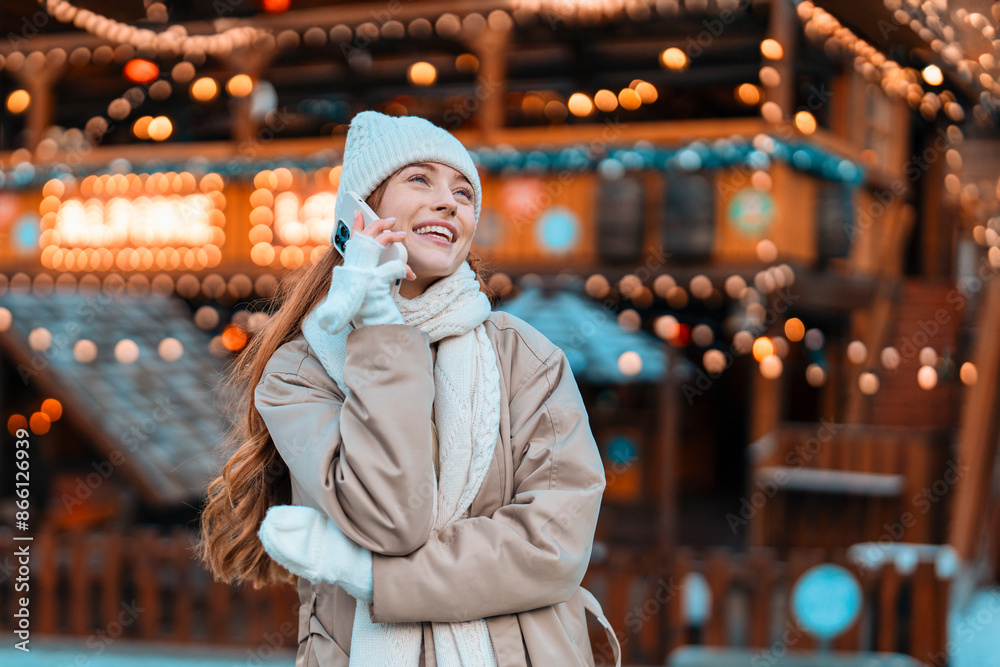 Woman in White Hat Smiles While Talking on Phone at Festive Market Woman in White Hat Smiles While Talking on Phone at Festive Market