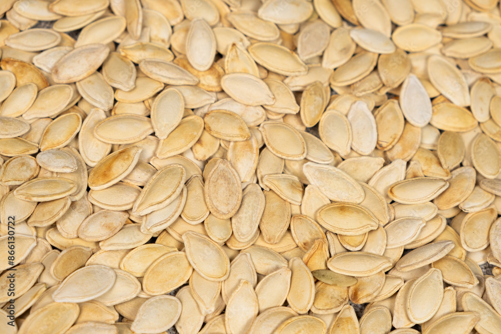 Close-up of unpeeled pumpkin seeds from above. Close-up of unpeeled pumpkin seeds from above.