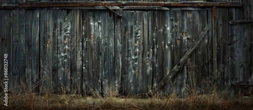 Background of a dilapidated barn featuring old wooden boards with a textural appearance ready for a copy space image.