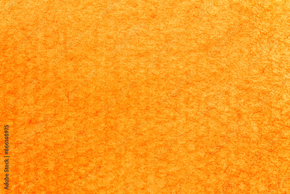 close up of textured watercolor paper stained in orange color close up of textured watercolor paper stained in orange color