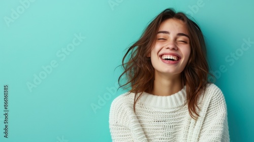 A portrait of a beautiful laughing girl in a white sweater on a turquoise background, radiating joy and happiness. AI generative photo