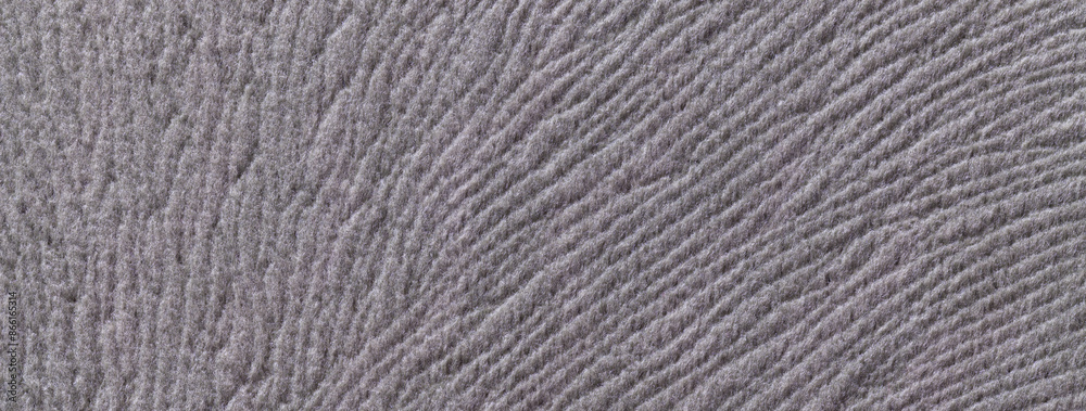 Texture of woolen dark gray textile background from soft wool material, macro. Grey fabric with wavy pattern. Texture of woolen dark gray textile background from soft wool material, macro. Grey fabric with wavy pattern.