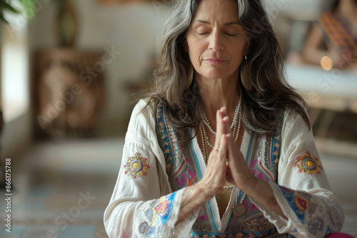 Middle-aged woman meditating in serene ashram