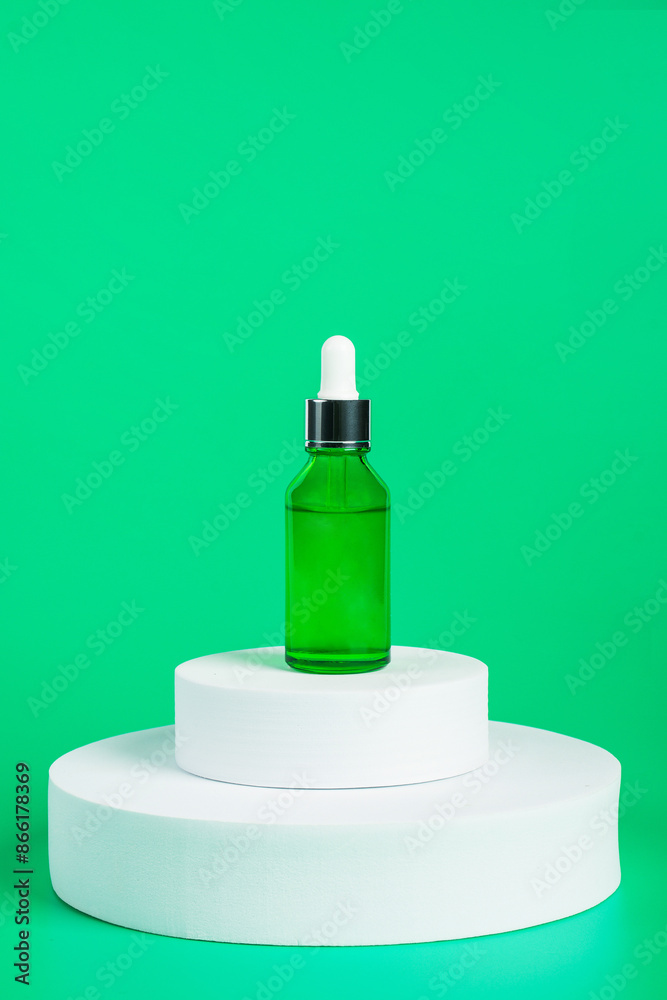 Green glass cosmetic bottle, Skin care or sunscreen cosmetic with stylish props on green background. Green glass cosmetic bottle, Skin care or sunscreen cosmetic with stylish props on green background.