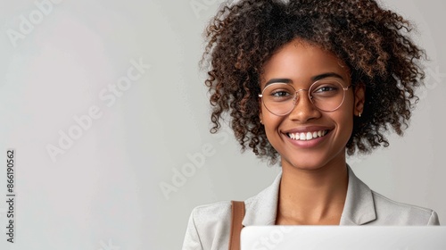 a joyful entrepreneur holding a laptop, smiling confidently on a white background, showcasing the innovation and drive in business, with ample copy space for text