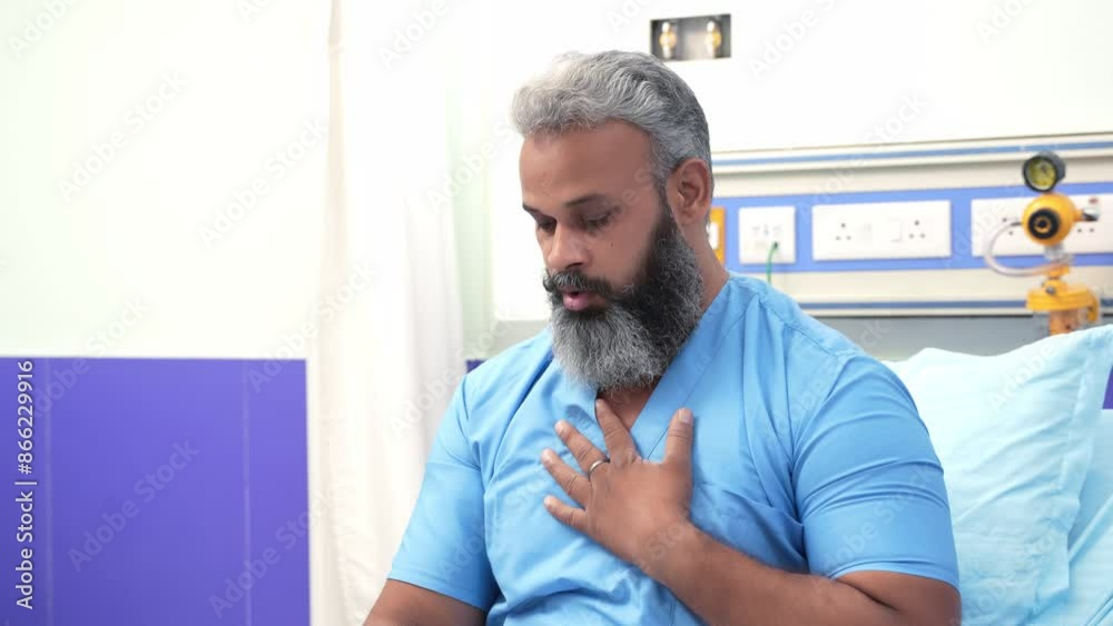 Indian male patient suffering from asthma attack touching his chest and using asthma inhaler for relief at hospital. 4k Indian male patient suffering from asthma attack touching his chest and using asthma inhaler for relief at hospital. 4k